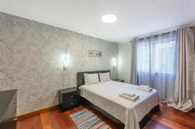 a small bedroom with a bed and a window at BoLina Ocean View in Caniço