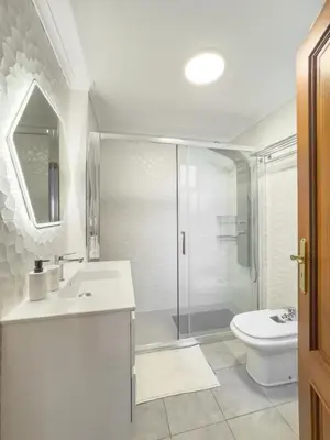 a bathroom with a shower and a sink and a toilet at BoLina Ocean View in Caniço
