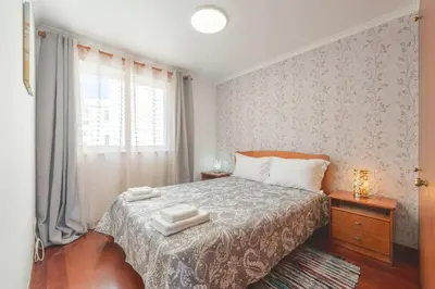 a bedroom with a bed with two towels on it at BoLina Ocean View in Caniço