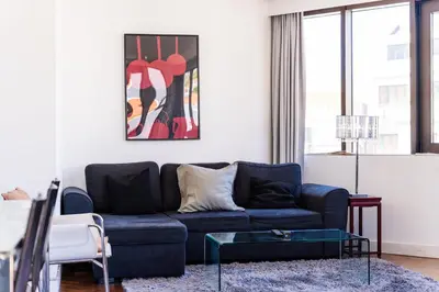 a living room with a blue couch and a table at GuestReady - Perfect home in the city centre in Funchal