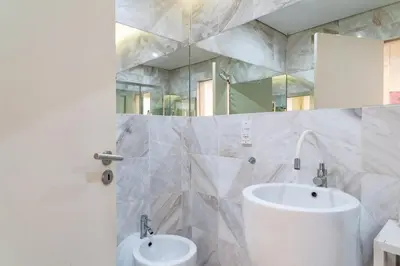 a white bathroom with a sink and a mirror at GuestReady - Perfect home in the city centre in Funchal