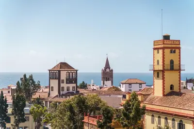 a city with towers and the ocean in the background at GuestReady - Perfect home in the city centre in Funchal