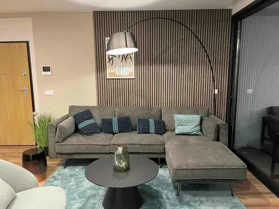 a living room with a couch and a table at Oceanfront Elegance Madeira Retreat in Câmara de Lobos