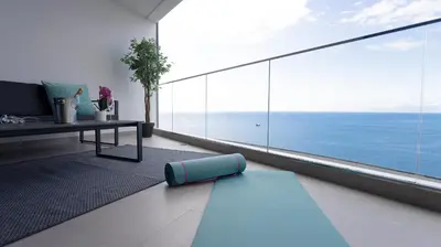 a living room with a large view of the ocean at Oceanfront Elegance Madeira Retreat in Câmara de Lobos