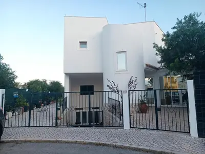 a white house with a gate in front of it at Costamar in Lagos