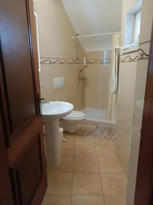 a small bathroom with a sink and a toilet at Costamar in Lagos