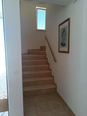 a staircase in a house with a picture on the wall at Costamar in Lagos