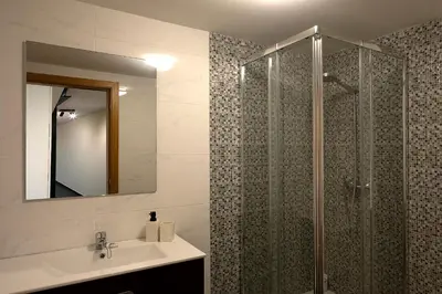 a bathroom with a shower and a sink and a mirror at Casa Pimenta in Fajã da Ovelha in Prazeres
