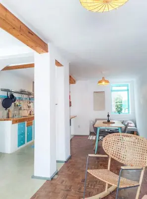 a room with a table and two chairs and a kitchen at Boho Bispo Apartments in Vila do Bispo