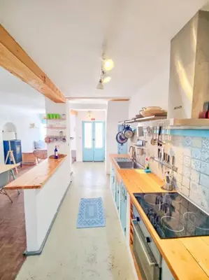a large kitchen with wooden counter tops in a room at Boho Bispo Apartments in Vila do Bispo