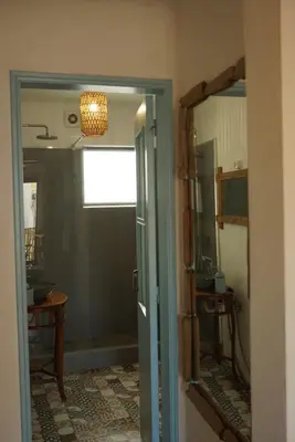 a hallway with a door to a room with a mirror at Boho Bispo Apartments in Vila do Bispo