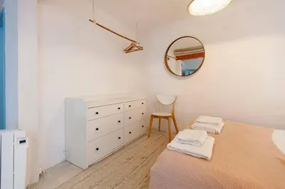 a white bedroom with a dresser and a mirror at Boho Bispo Apartments in Vila do Bispo