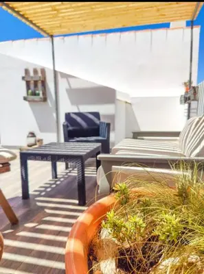 a patio with a table and chairs on a roof at Boho Bispo Apartments in Vila do Bispo