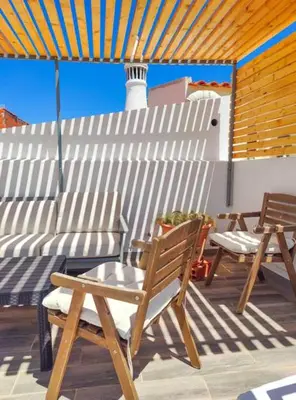 two chairs and a table on a patio at Boho Bispo Apartments in Vila do Bispo