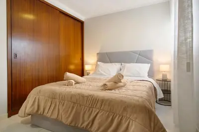 a bedroom with a large bed with stuffed animals on it at Madeira Funchal Stay in Funchal
