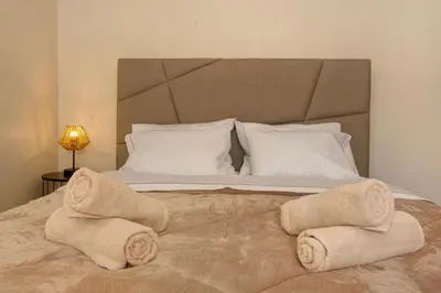 a bedroom with a large bed with towels on it at Madeira Funchal Stay in Funchal