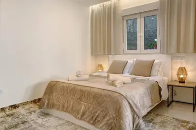 a white bedroom with a large bed with towels on it at Madeira Funchal Stay in Funchal