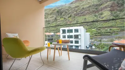 a room with a table and chairs and a large window at Brava Suite by LovelyStay in Ribeira Brava