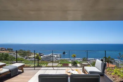 a view of the ocean from the balcony of a house at Savoy Monumentalis III by An Island Apart in Funchal