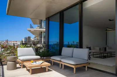 a patio with two chairs and a table on a balcony at Savoy Monumentalis III by An Island Apart in Funchal
