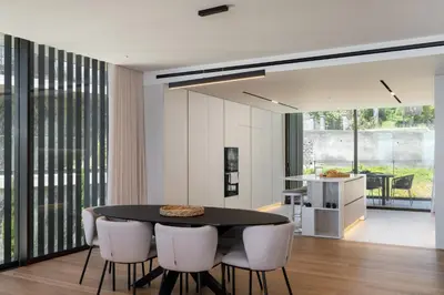 a dining room with a black table and white chairs at Savoy Monumentalis III by An Island Apart in Funchal