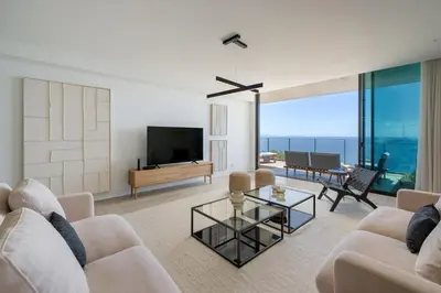 a living room with a couch and a tv at Savoy Monumentalis III by An Island Apart in Funchal