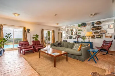 a living room with a couch and a table at Alto da Lua - Aljezur in Bordeira