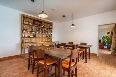 a dining room with wooden tables and chairs at Alto da Lua - Aljezur in Bordeira