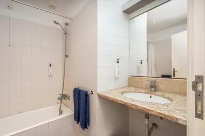 a bathroom with a sink and a tub and a mirror at Alto da Lua - Aljezur in Bordeira