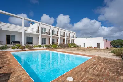 an image of a swimming pool in front of a building at Alto da Lua in Bordeira