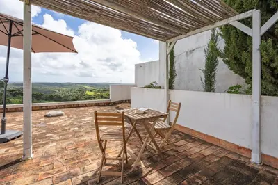 a swimming pool in a yard with a pavilion at Alto da Lua in Bordeira