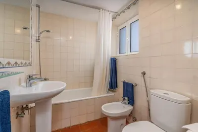 a bathroom with a sink and a toilet and a tub at Casa da Lua in Aljezur