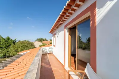 a balcony with a view of a house at Villa Azure Family & Surf Escape in Aljezur
