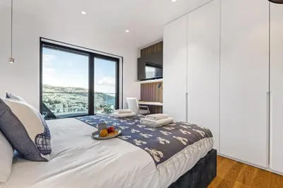 a bedroom with a large bed with a large window at Apartment Bay View - By WeHost in Funchal