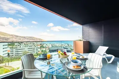 a dining room with a view of the ocean at Apartment Bay View - By WeHost in Funchal