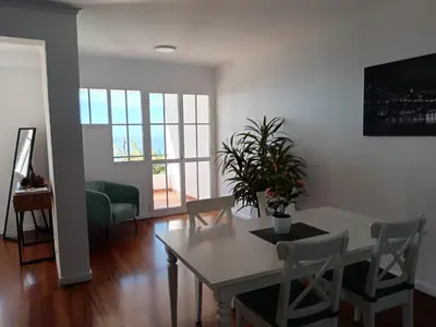 a living room with a white table and chairs at The Garajau Views in Caniço