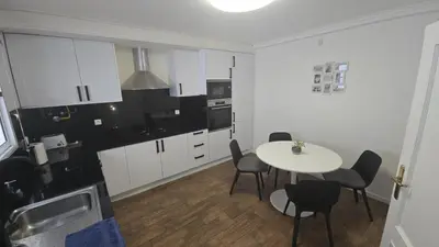 a kitchen with a table and chairs in a room at The Garajau Views in Caniço