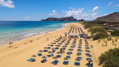 an aerial view of a beach with umbrellas and the ocean at Rosa Villa Porto Santo by YOUR KEY in Porto Santo