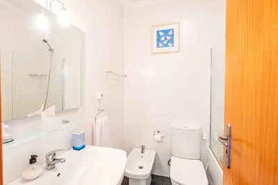 a white bathroom with a toilet and a sink at Rosa Villa Porto Santo by YOUR KEY in Porto Santo