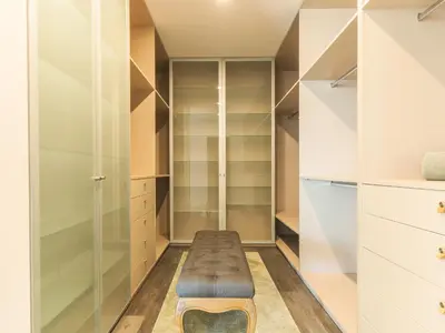 a walk in closet with a bench in it at Villa Primavera by Atlantic Holiday in Calheta