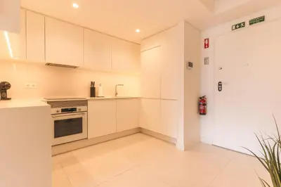 a kitchen with white cabinets and a stove at Acqua The Finnest by Atlantic Holiday in Funchal