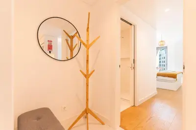 a mirror on a wall in a room with a chair at Acqua The Finnest by Atlantic Holiday in Funchal