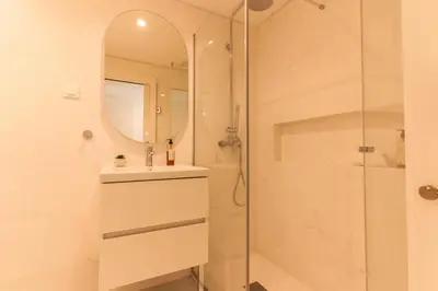 a bathroom with a shower and a sink and a mirror at Acqua The Finnest by Atlantic Holiday in Funchal