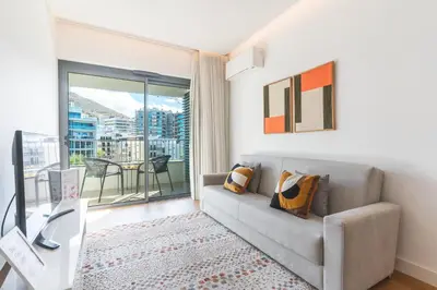a living room with a couch and a large window at Acqua The Finnest by Atlantic Holiday in Funchal