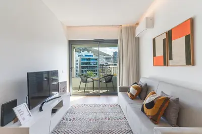 a living room with a couch and a television at Acqua The Finnest by Atlantic Holiday in Funchal