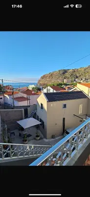 a balcony of a building with a table and umbrella at House Dino & Telma in Machico