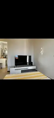 a living room with a flat screen tv on the wall at House Dino & Telma in Machico