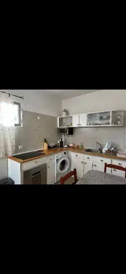 a kitchen with a sink and a washing machine at House Dino & Telma in Machico