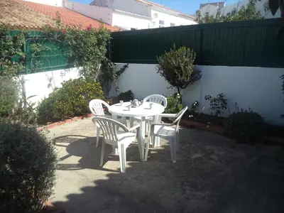 a white table and chairs sitting on a patio at Casa Margarida in Vila do Bispo