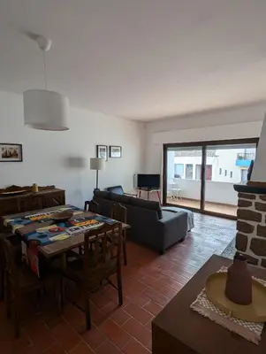 a living room with a couch and a table at Casa Margarida in Vila do Bispo